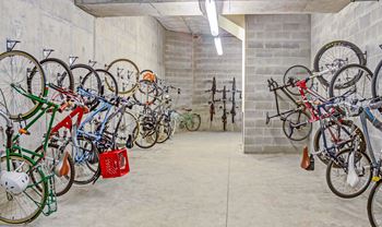 a large storage room with many bikes hanging on the wall